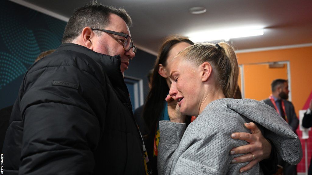 New Zealand Finance Minister Grant Robertson and former Prime Minister Jacinda Ardern congratulate a tearful looking C.J. Bott of New Zealand