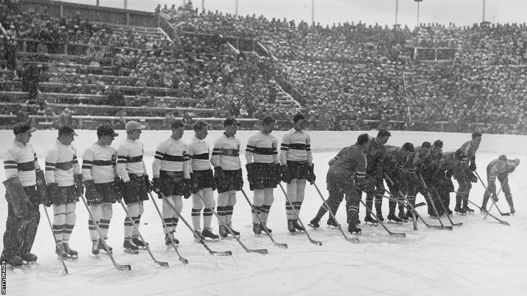 Germany line up to face the United States at the 1936 Olympics as snow falls