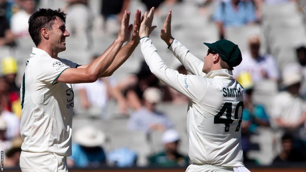 Australia's Pat Cummins and Steve Smith celebrate a Pakistan wicket in the second Test