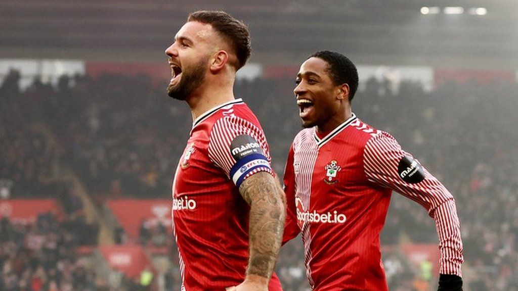 Adam Armstrong (left) celebrates a goal with Kyle Walker-Peters (right)