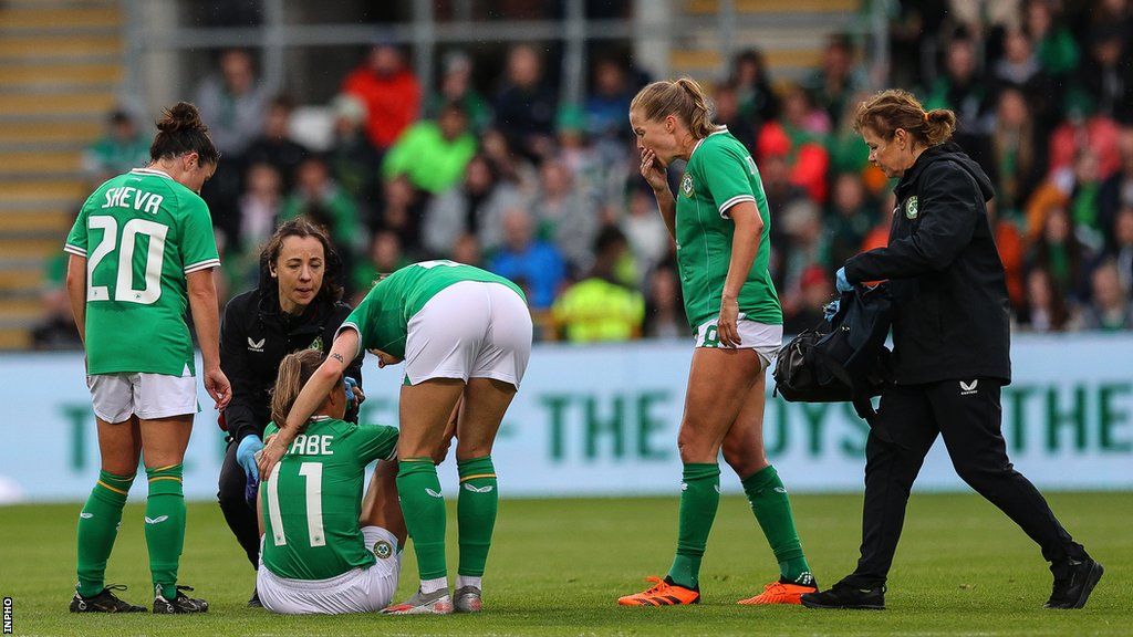Katie McCabe receives treatment on an ankle injury