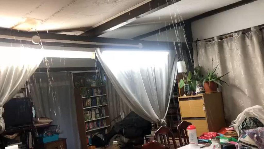 Water pouring through ceiling
