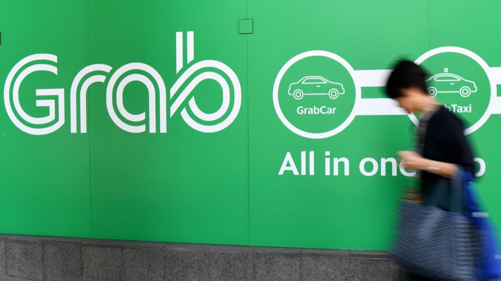 A woman walks past the Grab transport office in Singapore.