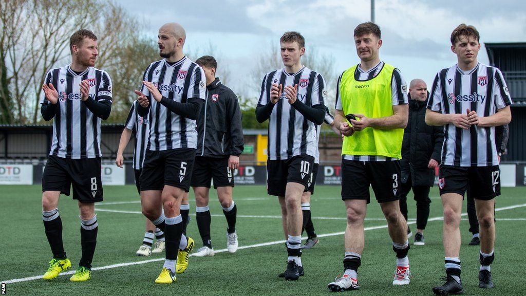 Flint Town United players applaud fans