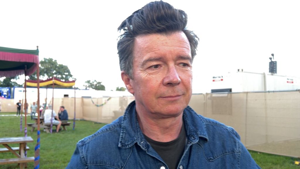 Rick Astley, wearing a denim jacket, while being interviewed backstage at Camp Bestival