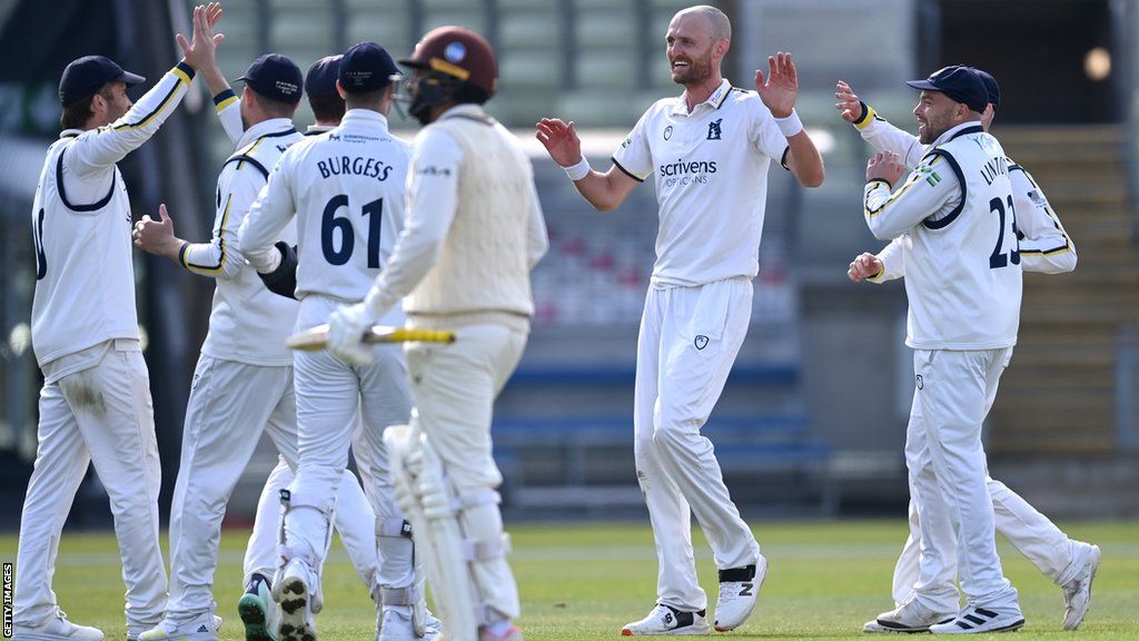 Olly Hannon-Dalby celebrates with his Warwickshire teammates during their County Championship Division 1 match against Surrey