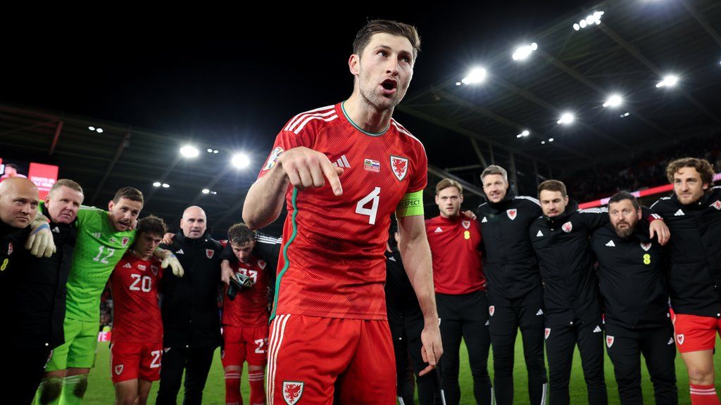 Captain Ben Davies gives a team talk at full time after Wales victory against Croatia