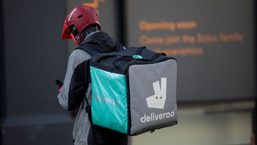 A Deliveroo rider making a delivery in London.
