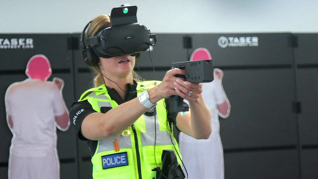 A police office wearing a virtual reality headset and gun