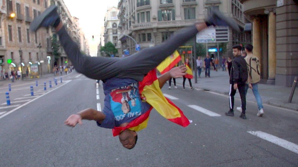 A Spanish nationalist dances in the street.