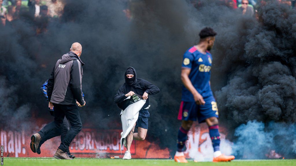 Groningen fan runs onto the pitch