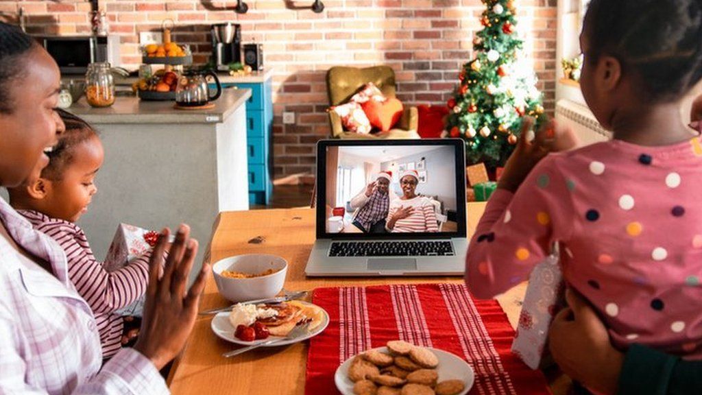 Stock photo of a family using zoom at christmas