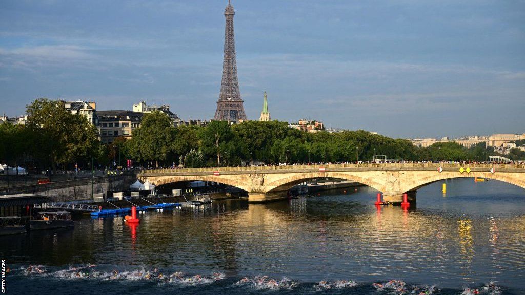 Triathlon athletes swim in the Seine river during the men's 2023 World Triathlon Olympic Games Test Event in Paris