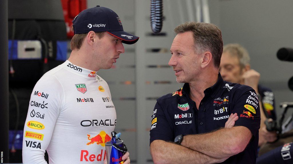 Max Verstappen and Christian Horner talk in the Red Bull garage