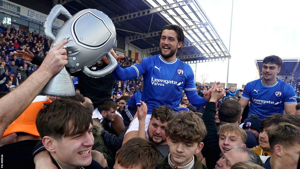 Chesterfield celebrate with their fans after clinching promotion