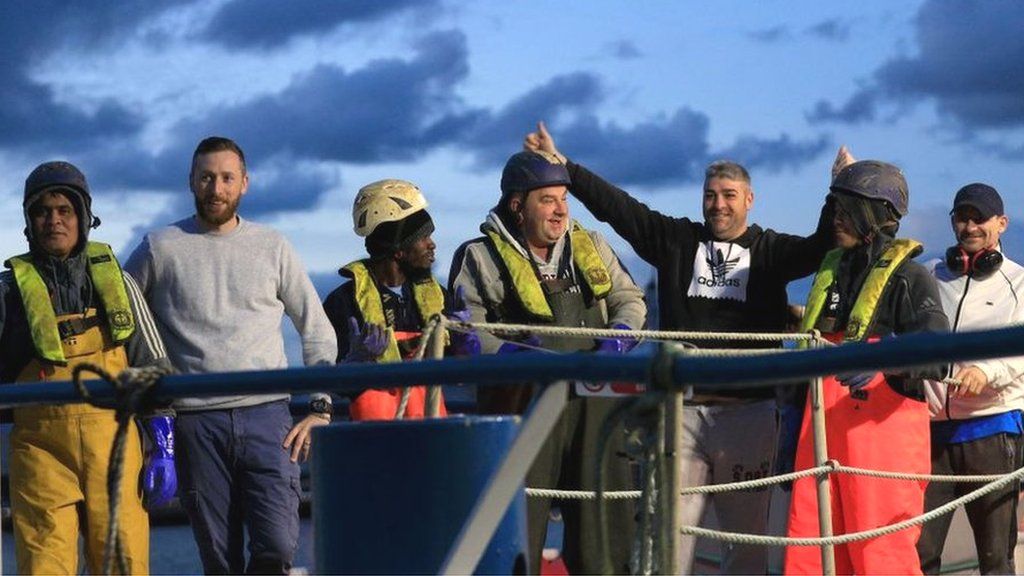 Crew members of the Scottish scallop trawler "Cornelis-Gert Jan" celebrate