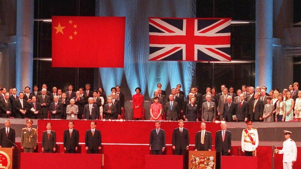 A general view of the handover ceremony showing the Chinese flag (L) flying after the Union flag (R) was lowered in Hong Kong in this July 1, 1997 file photograph.