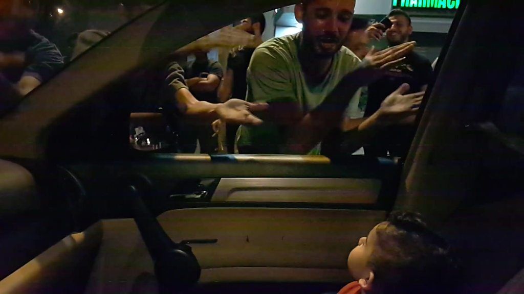 protesters sing to baby in car