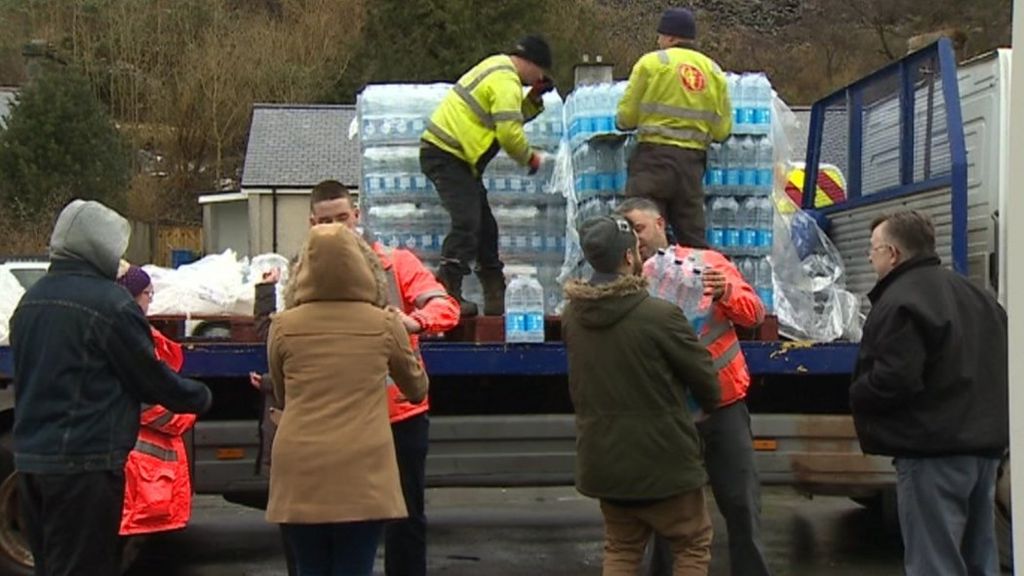 people getting bottled water in north Wales
