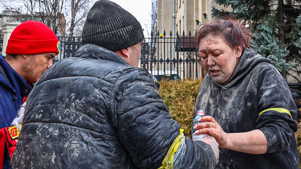 People help a wounded woman in Kharkiv, Ukraine, 1 March 2022