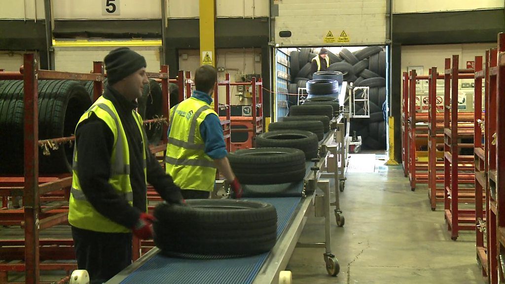 Tyres being delivered at a warehouse