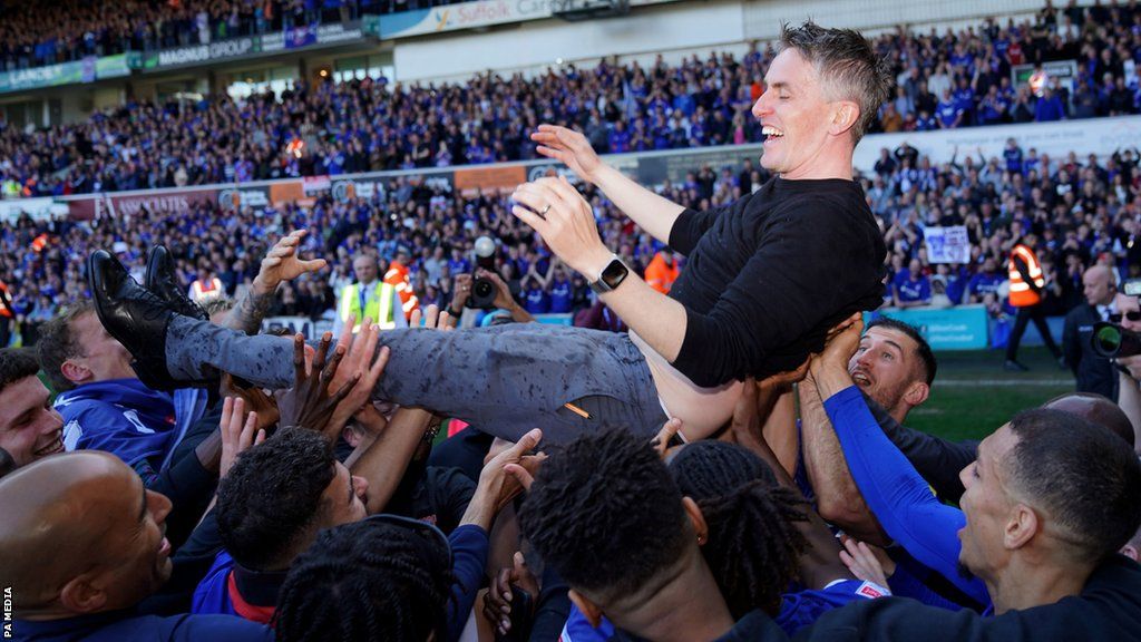 Ipswich Town manager Kieran McKenna is thrown into the air by the players as they celebrate promotion to the Championship