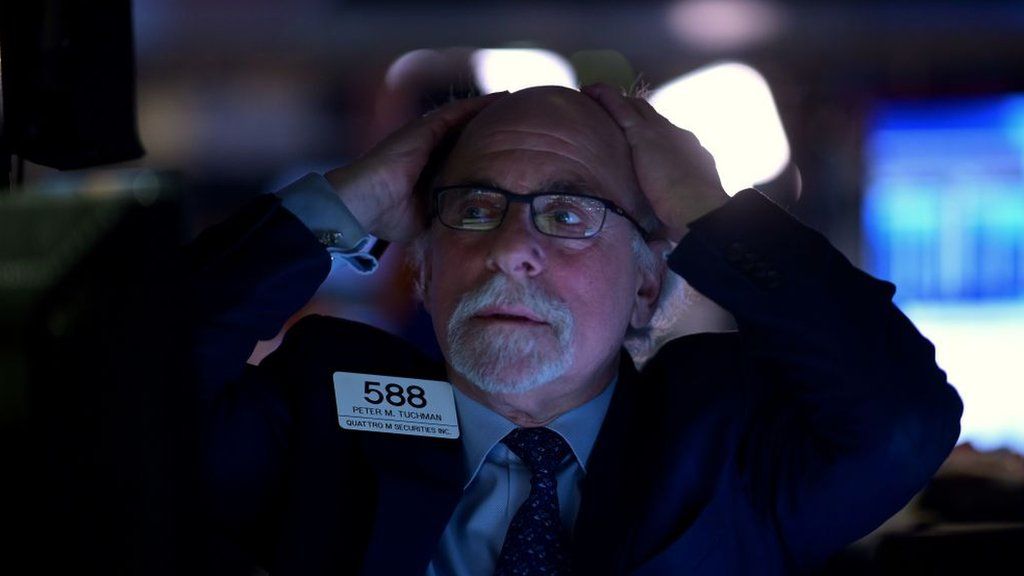 Trader at New York Stock Exchange looks despairing