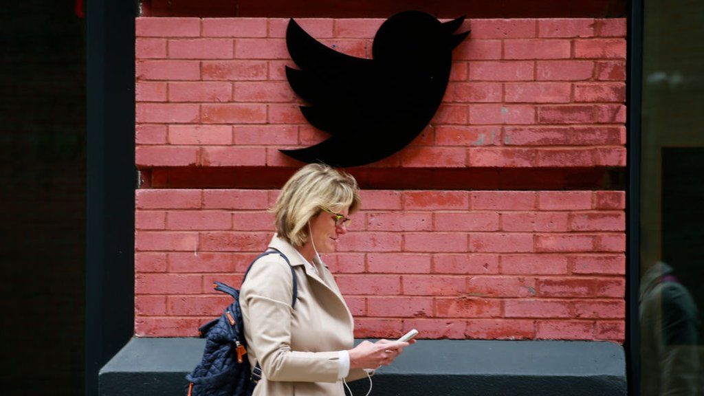 Woman walks by Twitter office in New York City