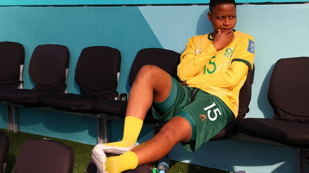 South Africa midfielder Refiloe Jane sits with her left leg raised in an empty dugout during the 2023 Women's World Cup
