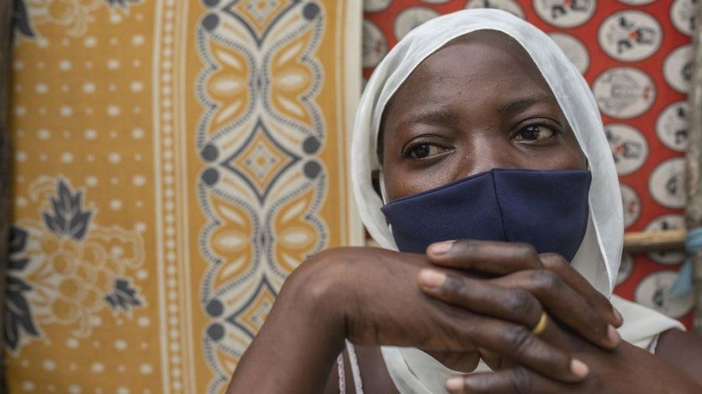 Woman in Mozambique wearing mask, fled conflict in Cabo Delgado province.
