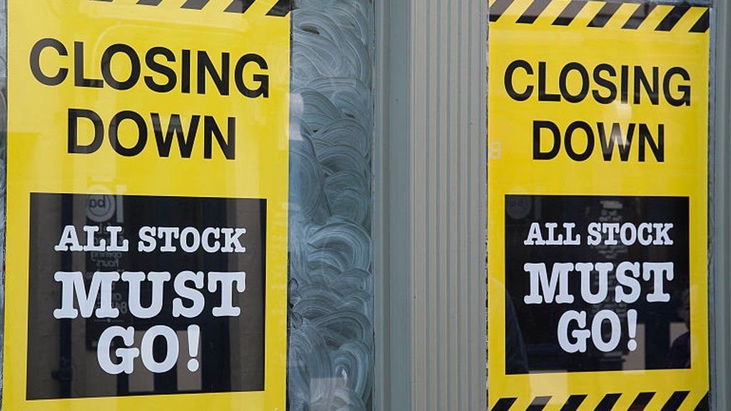 closing down signs in shop window