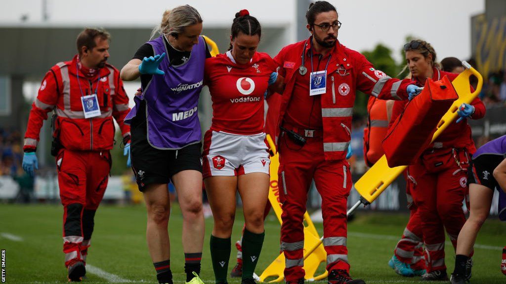 Ffion Lewis is helped off the field after an injury