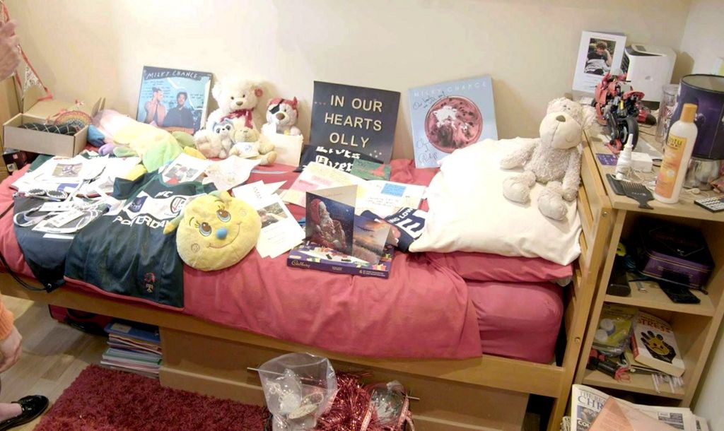 Olly's bedroom is filled with cards from well-wishers - his teddy Tarzan is on his bed