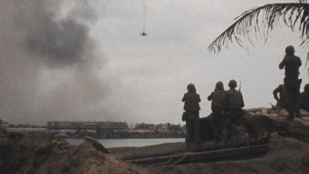 American soldiers watch an US aircraft bomb Communist positions in the city of Hue
