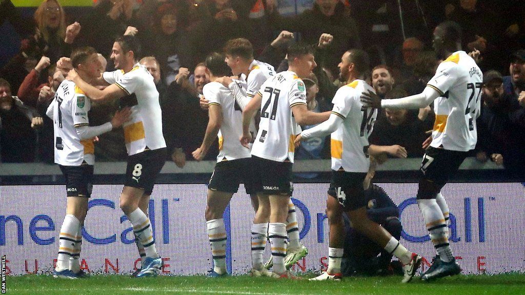 Port Vale players celebrate reaching the Carabao Cup last eight for the first time