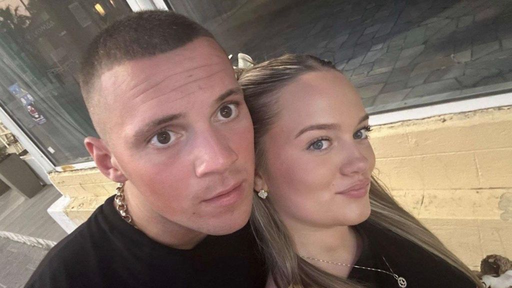 Lexie and Evan, a young couple in a selfie. They are both wearing black. Evan has short fair hair and Lexie has long blonde hair