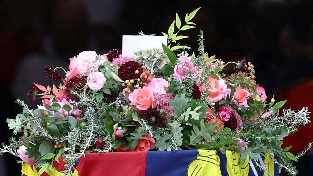 The personal touches in Her Majesty's colourful funeral flowers - BBC News