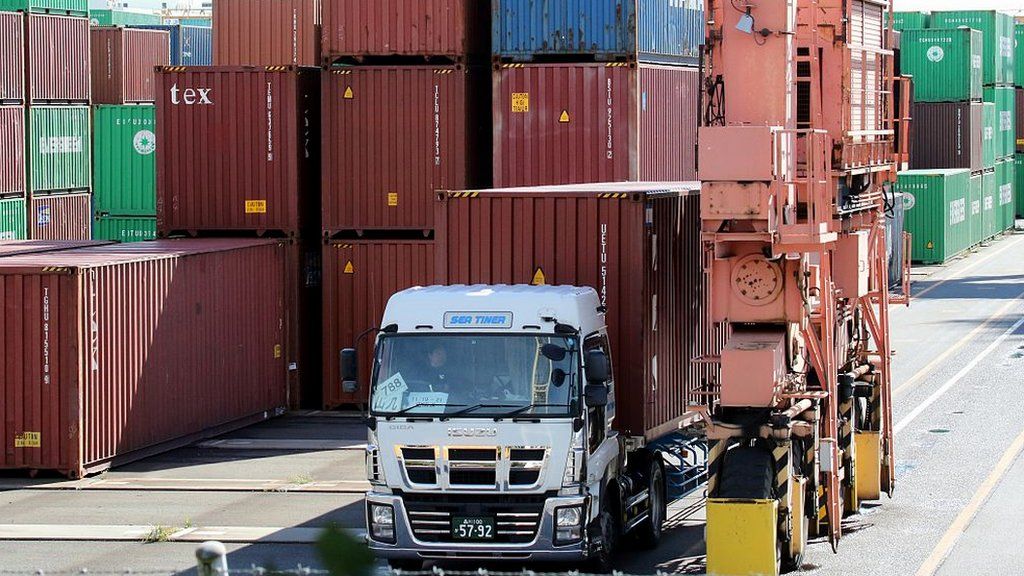 A truck leaves Tokyo's international cargo terminal