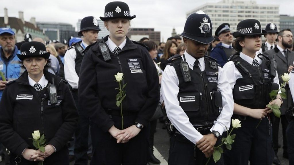 Police holding white roses on Westminster bridge