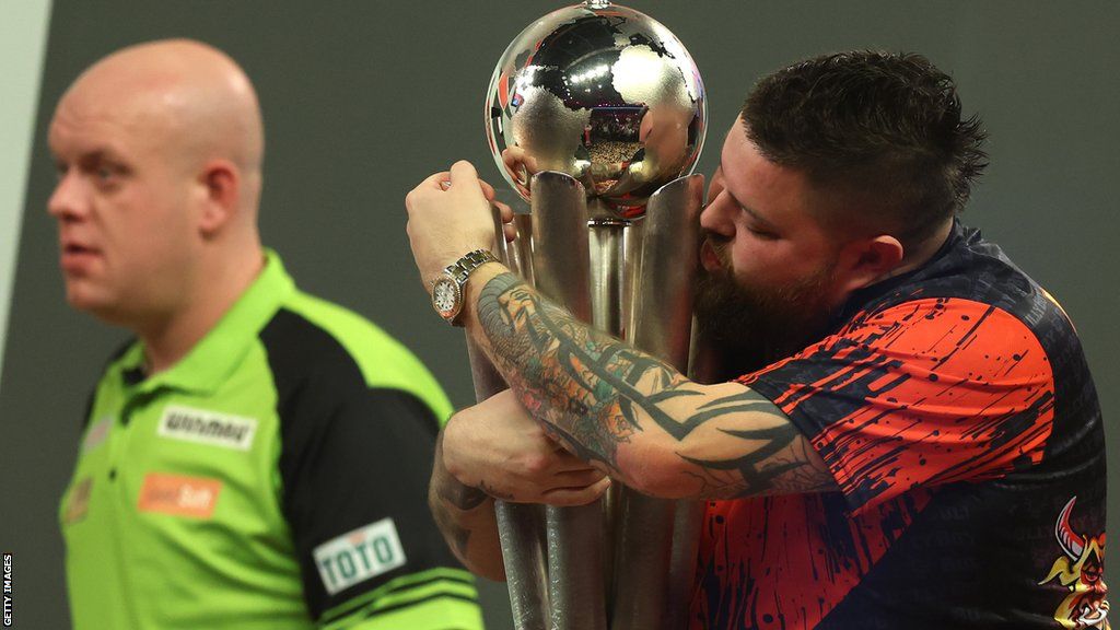 Michael Smith holds the PDC World Darts Championship trophy
