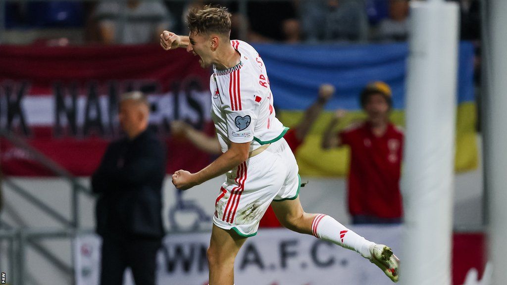 David Brooks celebrates after Wales' win in Latvia