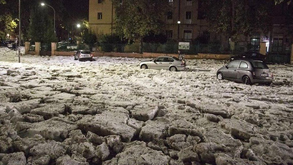 Cars stranded in thick snow and hail in Italy.