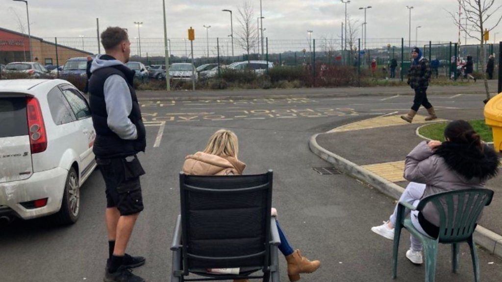 People on chairs blocking the road