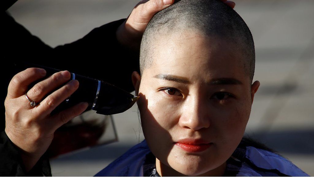 Li Wenzu has her head shaved in protest in Beijing