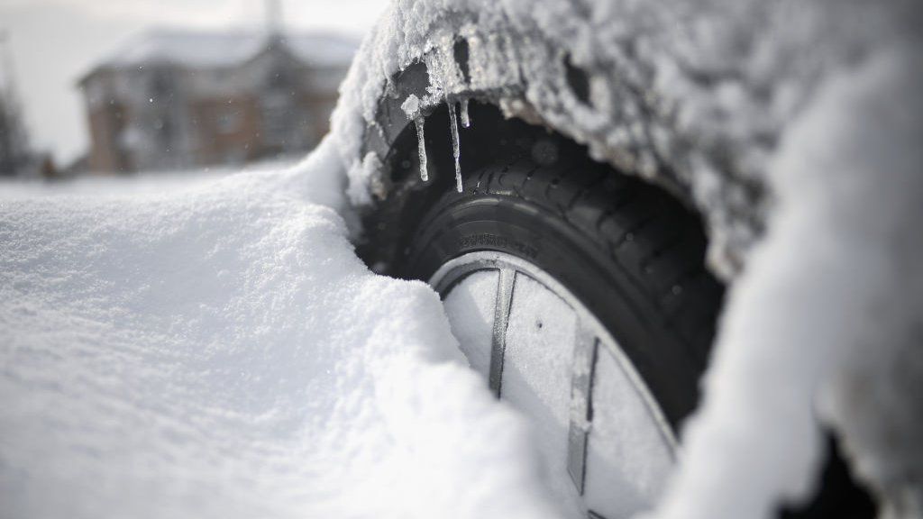 car wheel in deep snow and ice