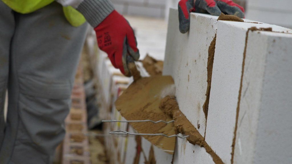 Construction worker laying bricks