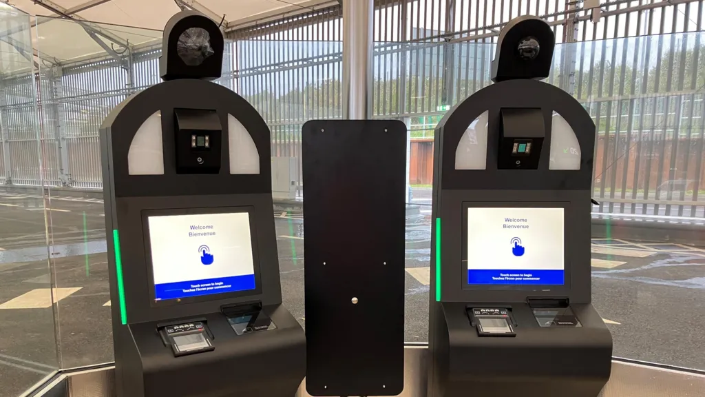Two of Eurotunnel's EES kiosks. Each machine has a camera and a touchscreen which reads 