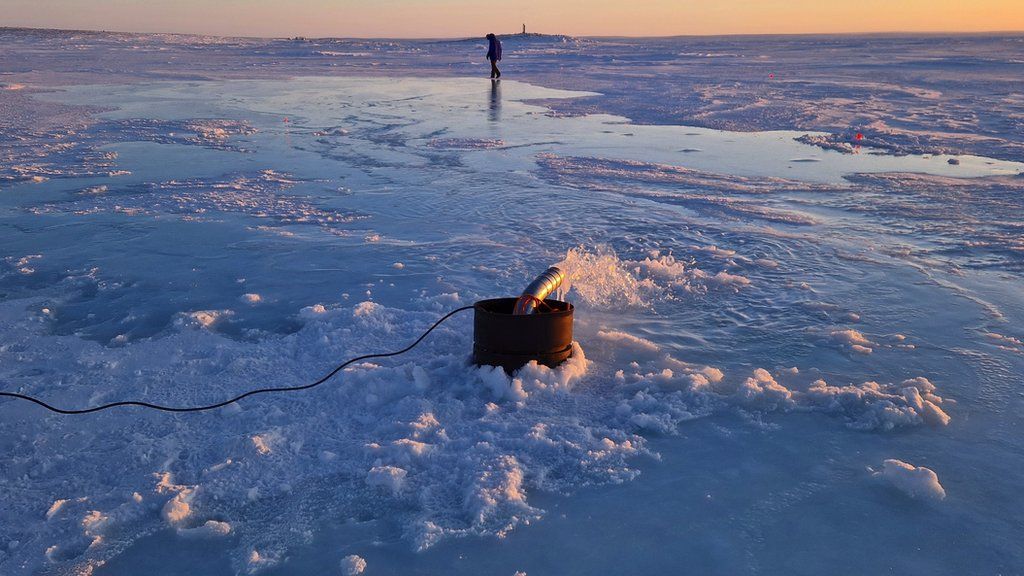 Seawater pump in action with Arctic sunset in the background