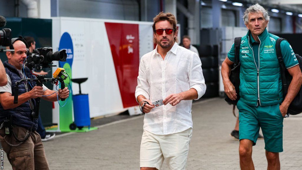 Fernando Alonso arrives in the Interlagos paddock