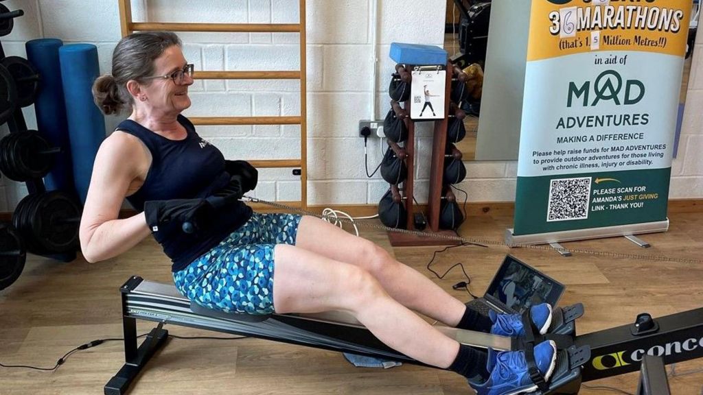Woman on rowing machine in gym